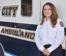 New Lake City Ambulance Director Sara Rybarczyk next to one of the service’s ambulances. Rybarczyk had been interim director since February.